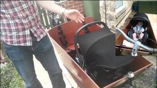 Carrying an infant in a Bakfiets using maxi cosi and rain tent [upl. by Enenaej]