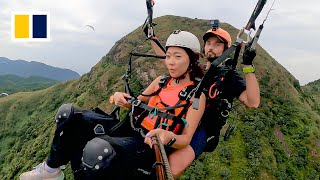 Paragliding offers birds eye view of Hong Kong [upl. by Enellij172]