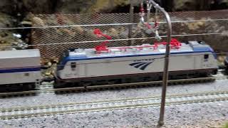 NScale Amtrak ACS64s traversing the last bit of nature before hitting urbania Model Railroad Fun [upl. by Norita]