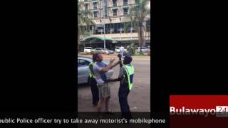 Zimbabwe Republic Police traffic cops try to take away motorists mobilephone [upl. by Acilejna]