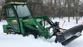 Plowing snow  tar and chip driveway  and getting stuck with the John Deere tractor 4K [upl. by Haniraz892]