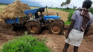 New holland 4710 tractor with loaded taylor stuck in mud farmers life [upl. by Drofxer]