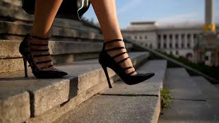 Feet in high heels of a woman walking down steps [upl. by Digdirb]