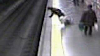 Fainting woman falls on train tracks [upl. by Lekzehcey]