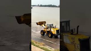 Loader loading water to clean the road at the ferry terminal Ferry crossing the river Safety i [upl. by Notyrb300]