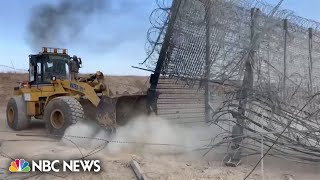 Watch Bulldozer tears down section of IsraelGaza border fence [upl. by Kcirdot]