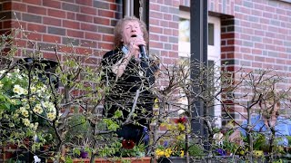 Coronavirus Musician Geff Harrison sings for neighbours from Hamburg terrace  AFP [upl. by Rebeca]