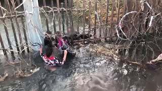 Dramatic moment migrants cross fence along canal at USMexico border [upl. by Blas]