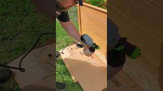 Applying cedar stain to the raised garden beds [upl. by Limhaj]