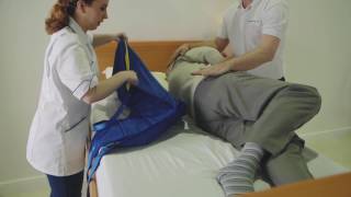 Transferring from a bed to a chair featuring the Application of a Universal Sling and A 150F Folding [upl. by Annaeiluj812]