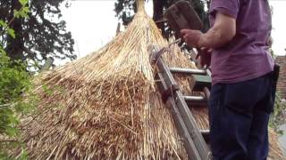 Thatching a round straw roof iron age hut thatch style [upl. by Erdeid]