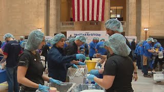 Volunteers fill Chicagos Union Station to pack meals for Day of Service [upl. by Guinn]