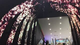 Flexible LED screen display building on escalator in Rive Gauches store St Petersburg Russia [upl. by Kolb]