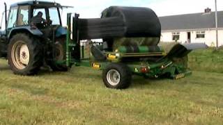 Wrapping bales with a conor wrapper and new holland tractor [upl. by Egas]