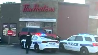 Wild getaway attempt at Tim Hortons drivethru  Suspect drives over police cruiser [upl. by Queridas516]