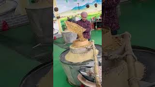 The process of grinding grains into powder with stone mills [upl. by Leiahtan]