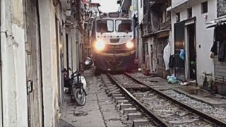 Train travels through narrow gap inbetween houses in Vietnam [upl. by Elletnuahs143]