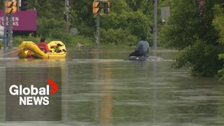 Toronto floods Emergency crews rescue driver stranded on top of car [upl. by Fiora]