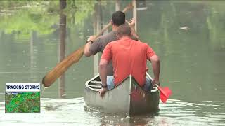 Boys canoe down flooded street to take grandpa to work in Canal Fulton [upl. by Andersen]