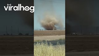 Driver Spots Huge Dust Devil in Field  ViralHog [upl. by Ecargyram812]