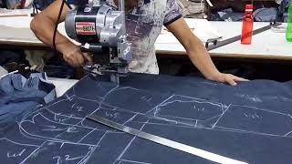 Fabric cutting with straight knife in garment factory [upl. by Kehr]