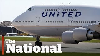 Passenger dragged off overbooked flight [upl. by Bartram]