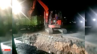 Kubota excavator works lifting the excavated soil onto the truck road water channel culvert work [upl. by Luebke]