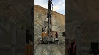 Drilling blast holes in an open pit mine The holes are filled with explosives and detonated [upl. by Boothman572]