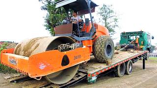 Loading Delivery Unloading Soil Compactor From The Road Construction Site Using Self Loader Trucks [upl. by Rennold]