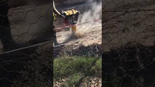 Vibrating rammer plate at a construction site Compaction of soil before laying [upl. by Eciral372]