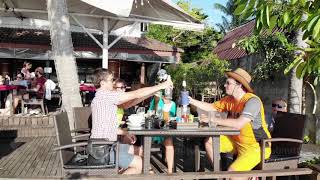 Happy friends clinking of glasses of beer drinks in beach cafe at beautiful sunset View from drone [upl. by Bethanne]