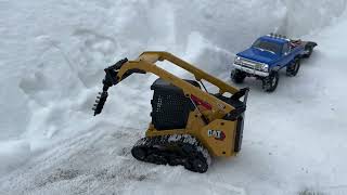 Pushing snow and auger test RC skid loader CAT 297D2 Chevy K10 Trx4m [upl. by Johanan]