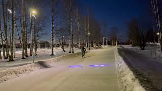 Oulu  A projector light which illuminates traffic signs on a snowy surface of a cycling path [upl. by Irmgard619]