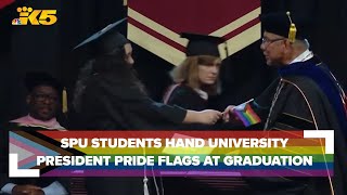 SPU students hand university president pride flags instead of shaking his hand at graduation [upl. by Bik956]