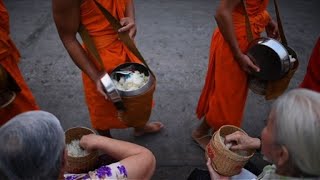 Almsgiving ceremony for Buddhist monks in Luang Prabang [upl. by Eanal16]