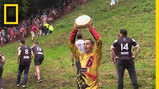 Watch a Downhill CheeseChasing Competition in Britain  National Geographic [upl. by Aniala]