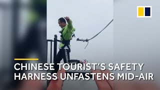 Safety cord tied to Chinese tourist unfastens midjump on highaltitude bridge [upl. by Kessiah]