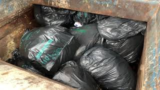 Compactor crushing black bags Full HD [upl. by Okoyk]