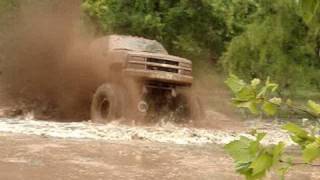 EPIC HUGE CHEVY 4X4 MUD TRUCK BLASTING THROUGH SLOUGH at Red River Mud Bog [upl. by Nellek]