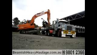 Side Loading excavator onto Folding Gooseneck Low Loader [upl. by Sidell550]