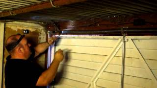 How to adjust the spring tension on a garage door in Manchester [upl. by Ettenowtna]