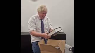 Boris Johnson opens a box full of copies of his book [upl. by Aohk]