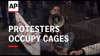 Protesters block Tel Aviv road and occupy cages as they demand return of hostages still held in Gaza [upl. by Lekcim]