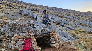 designing a majestic stone shelter with a fireplace beneath mountain overhangs at the mountain base [upl. by Akilat]