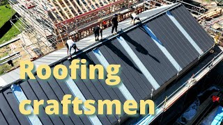 Roofing craftsmen install a standing seam roof [upl. by Nesiaj]