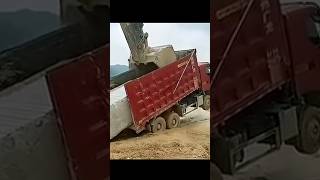 The process of loading a stone block onto a truck body using an excavator [upl. by Goldi]