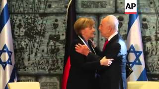 Peres confers upon Merkel Israels highest civilian award [upl. by Cristionna816]