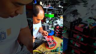 Repairman repairing electrical appliances with soldering iron and tin solderingshorts [upl. by The]