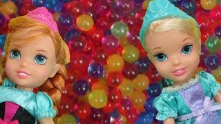 Elsa and Anna toddlers have fun in ORBEEZ  They slide into colorful water beads [upl. by Babbette]