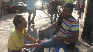 Luodong Massages Black Mans Knee On Sidewalk [upl. by Nicola938]